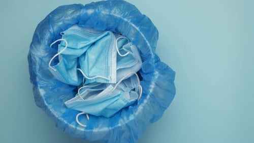 Used Face Masks Discarded in Waste Basket