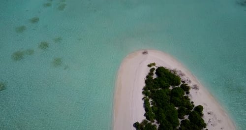 Tropical above island view of a paradise sunny white sand beach and blue ocean background in 4K
