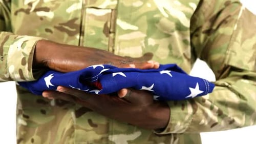 Military Man Holds American Flag