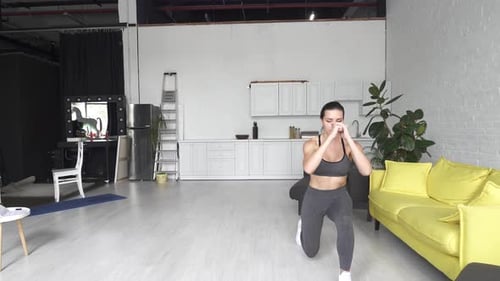 Beautiful Young Woman Doing Fitness at Home