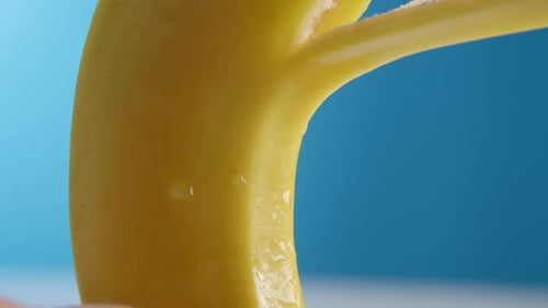 Close-up of Ripe Yellow Banana Being Peeled