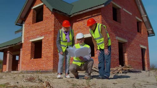 Realestate Agent Selling New House to Senior Grandmother Grandfather Showing Building Blueprints