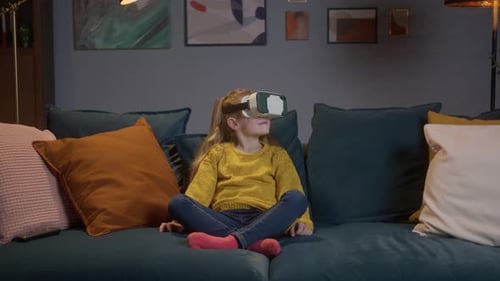 Child Wearing Virtual Reality Headset on Sofa