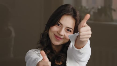 Woman Gives Double Thumbs Up of Approval