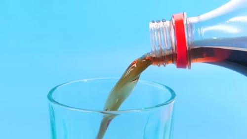 Soda Beverage Pouring into a Clear Glass