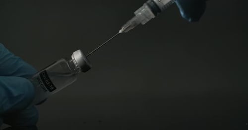 Vaccine Being Drawn into Syringe by Medical Professional
