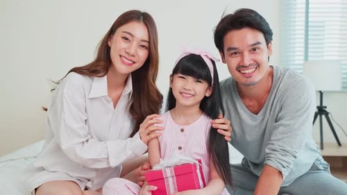 Happy Family Celebrating Child's Birthday with Gift