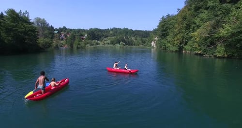 Friends Kayaking on a Lake in Summer