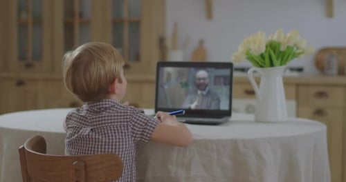 Preschool Kid Making Online School Homework with Teacher on Laptop Screen. Boy Studying Online at
