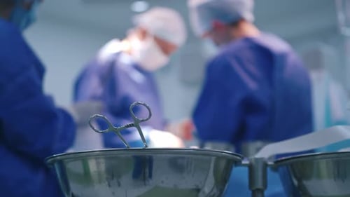 Surgical Instruments with Medical Professionals Performing Surgery