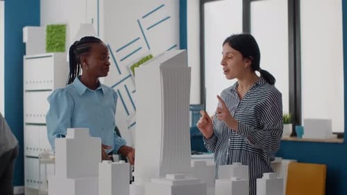 Team of Women Giving Highfive After Architecture Work Progress with Building Model