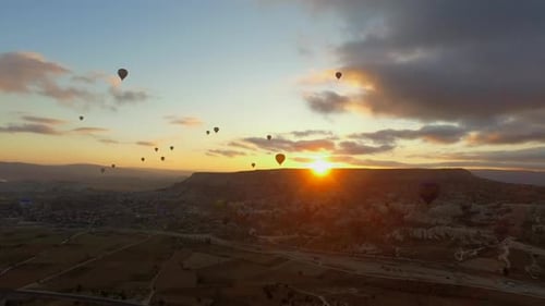 Balloons in Cappadocia Landscape at Sunrise