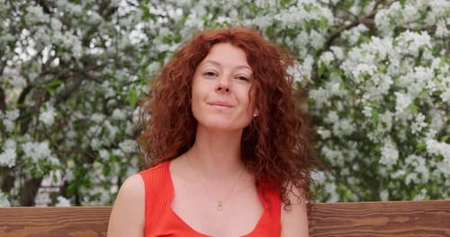Portrait of a Woman Sitting in a Park Looking at the Camera