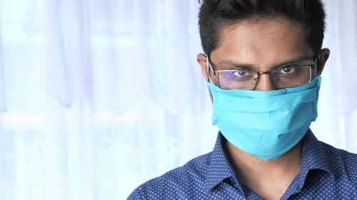Close Up of Man with Protective Face Mask Looking at Camera