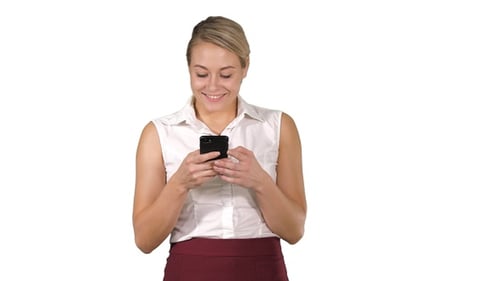 Woman Smiles while Using Mobile Phone