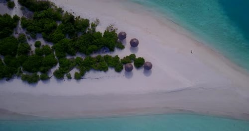 Natural fly over copy space shot of a white sand paradise beach and turquoise sea background in vibr