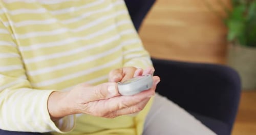 Video of midsection of caucasian senior woman checking glucose level