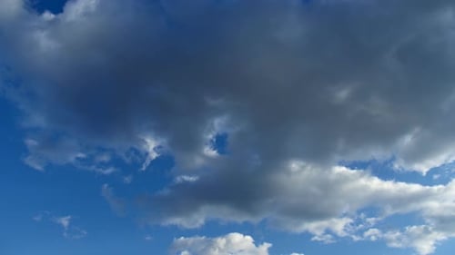 Cirrus Clouds in a Clear Blue Sky. White Clouds Move Across the Sky in Spring.