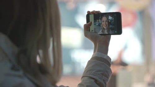 Woman Takes Selfie With Smartphone in City