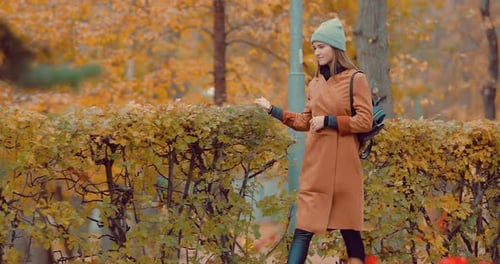 Young Girl Walking in Autumn Park