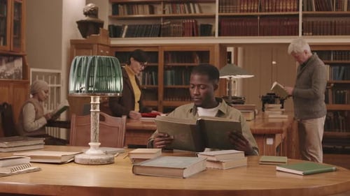 Diverse People Reading Books at Library