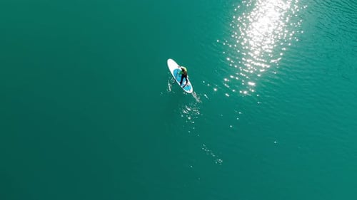 Man Is Paddling on Sup Board in the Mountain Lake