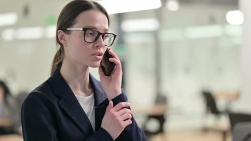 Woman Talking on Smartphone in Modern Office