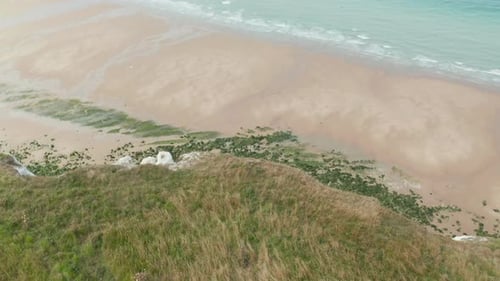 Green Grass with Ocean View, Aerial Tilt Down Revealing Steep Cliff