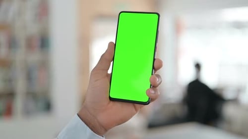 African Man Using Smartphone with Green Chroma Key Screen