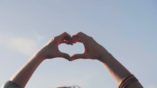 Woman's hands making heart shape