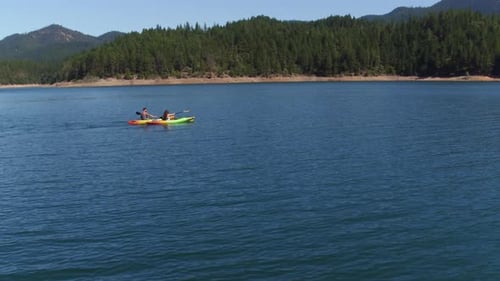 Aerial drone shot of couple kayaking on lake
