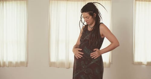 Pregnant woman holding her belly