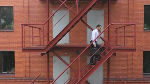 Businessman Climbing Up the Stairs of a Business Centre