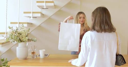 The Buyer is Taking Purchase In Fashion Clothes Boutique
