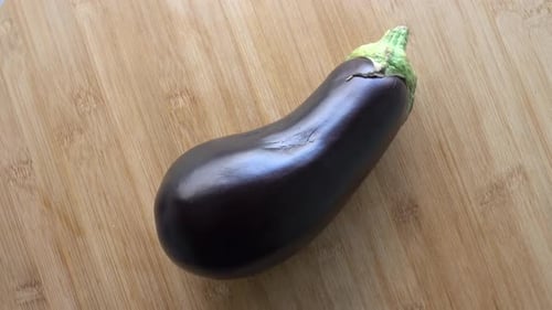 Close-Up of Vibrant Eggplant on Cutting Board
