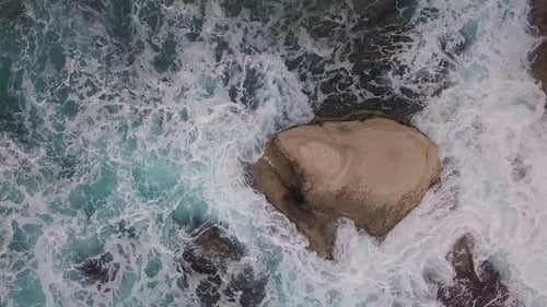 Aerial View of Crashing Waves on Rocks