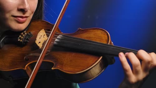 Professional Violin Playing. Close-up Instrument in the Hands of a Young Woman Musician. Slow Motion