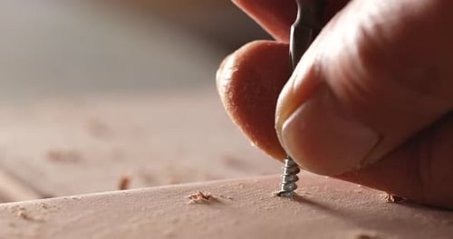Close Up of Wood being Drilled and Screwed