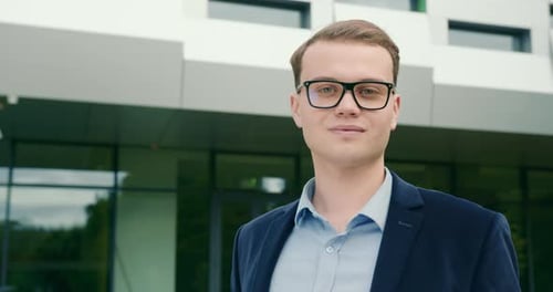 The Businessman is Looking at the Camera and Smiling