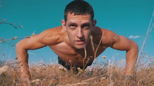 Workout. Pushups Fitness Man Doing Push-ups Outside on Nature.
