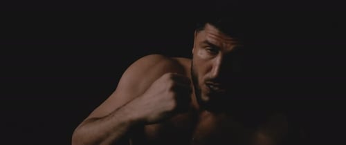 Muscular Boxer Shadow Boxing in Dramatic Lighting