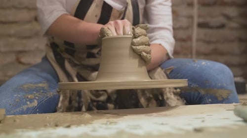 Hands Shaping Clay on Potter's Wheel