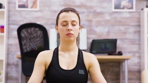 Woman Meditating With Eyes Closed in Office