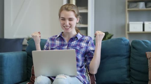 Woman Using Laptop at Home is Happy