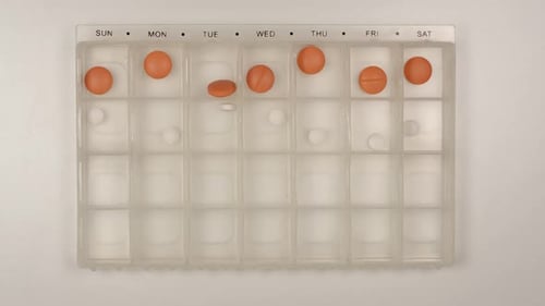 Pills Being Sorted Into Pill Organizer