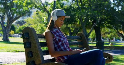Woman listening music in park