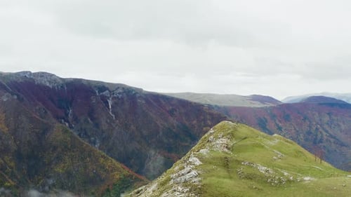 Aerial View of a Mountain Rocky Peak Overlooking the Valley