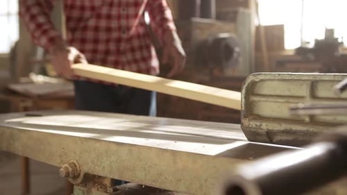 Close Up Footage of Caucasian Male Putting Wood Plank on Jointerplaner Machine