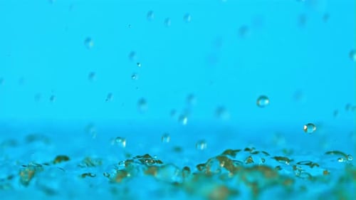 Water Droplets Splashing on a Blue Background