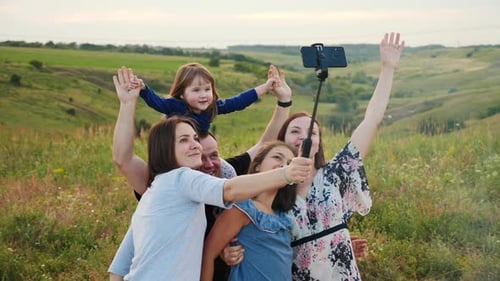 Happy Family Hugging Makes Selfie on Smartphone